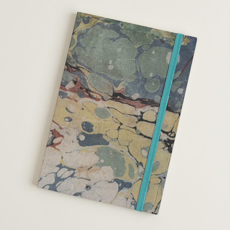 marbled notebook with teal elastic band
