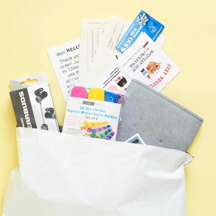 all of the items in the mini monthly mystery box for october coming out of the package