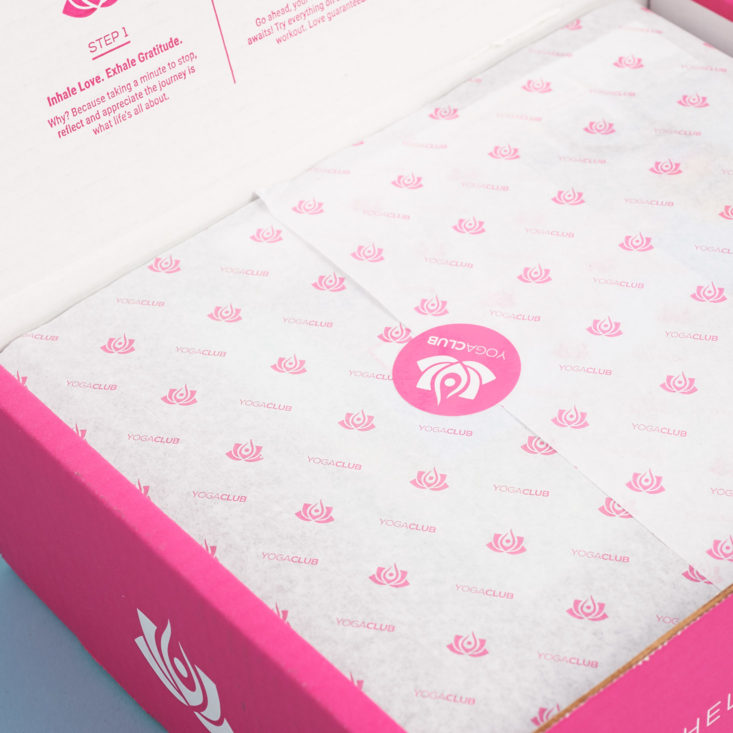 inside of a yoga club box with wrapped items