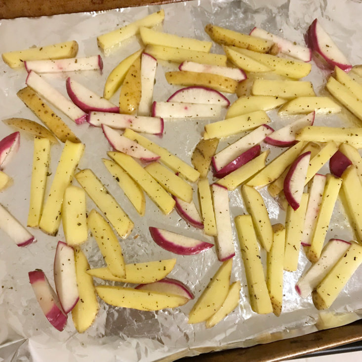 sliced potatoes and turnips on baking sheet