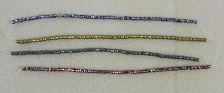 four strands of colorful beads
