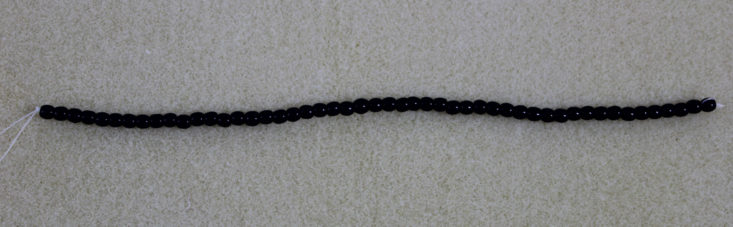 dark colored small beads on a strong