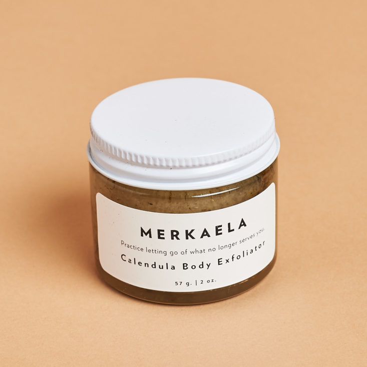 Calendula body exfoliator in a small jar with white lid