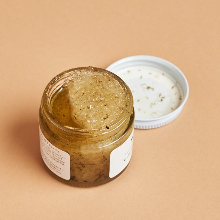 small glass jar of calendula exfoliator with the lid off