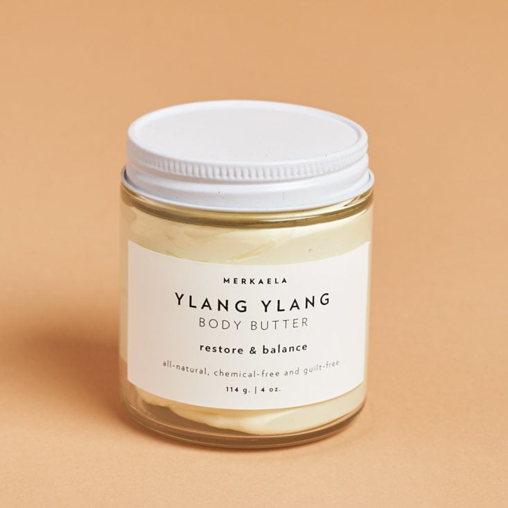 glass jar of ylang ylang body butter