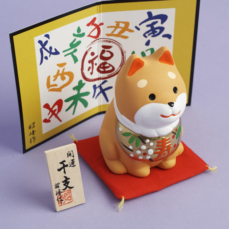 3/4 angle of Shiba Inu Statuette with background and pillow