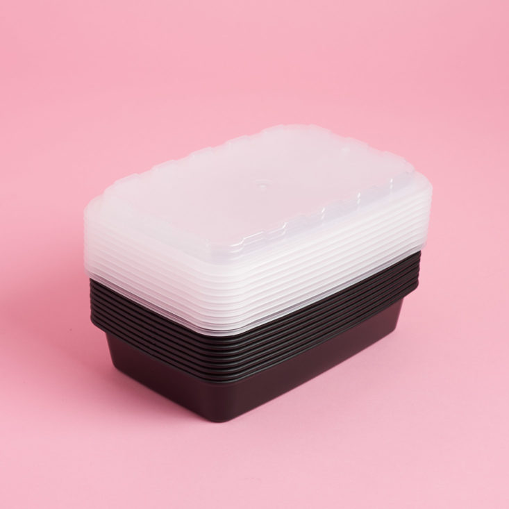 unwrapped food containers with black bases and clear plastic lids