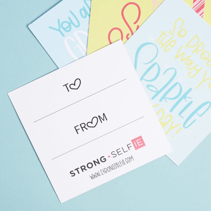 the back of a strong selfie gift tag card