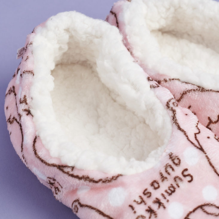 close up of inside of pink Sumikko Gurashi slippers