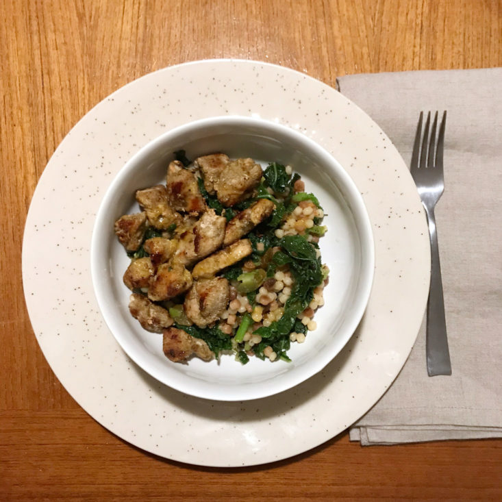 Plated Tuscan-spiced chicken and fregola sarda with warm citrus vinaigrette