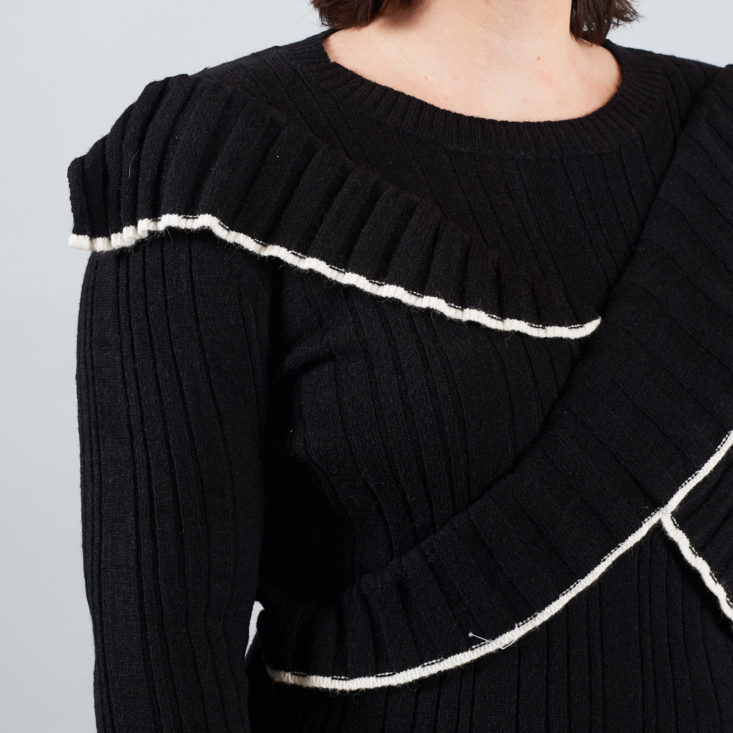 white trim black ruffle sweater