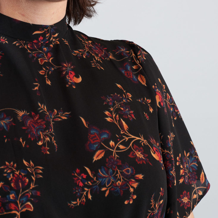 close up on orange details on black dress