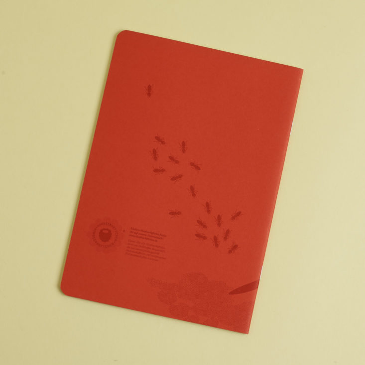 back of red notebook with ants