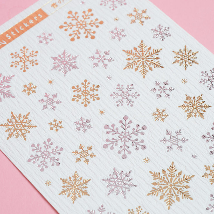 close up of silver and gold snowflake stickers