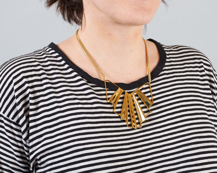 gold deco necklace on woman