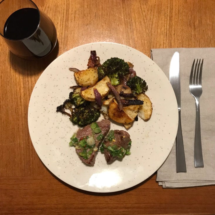 beef medallions and scallion salsa verde with potatoes and broccoli. plated
