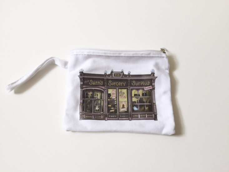 white cotton bag with magical supplies store front printed on front