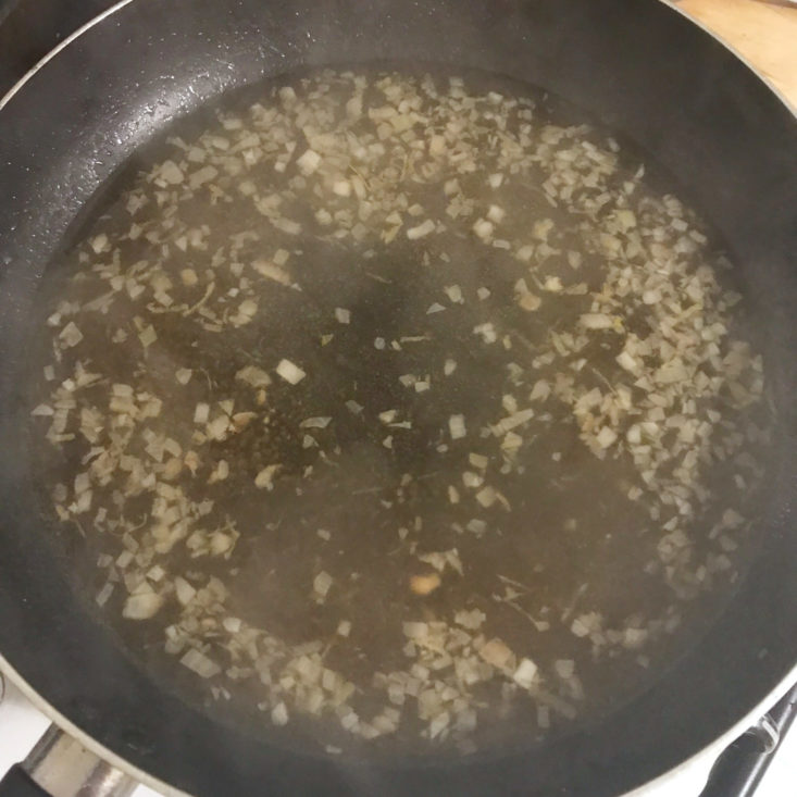 chopped shallots cooking in pan