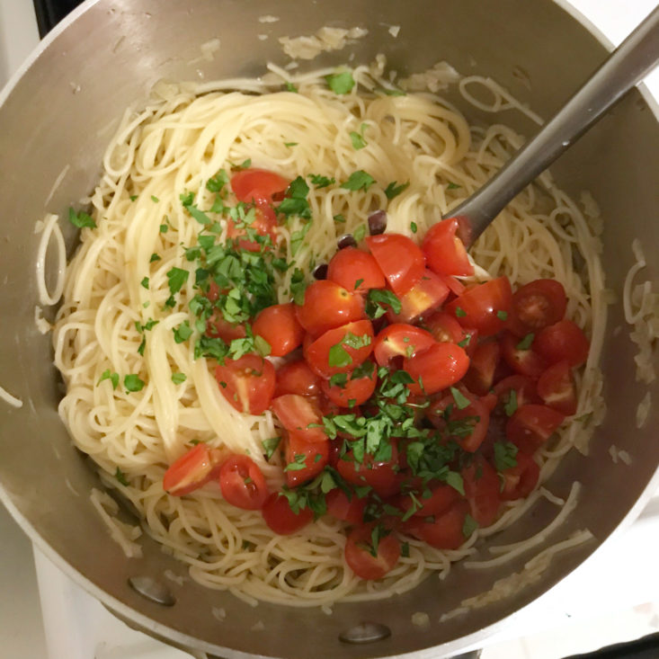 tomatoes, parsely, and sauce with angel hair pasta