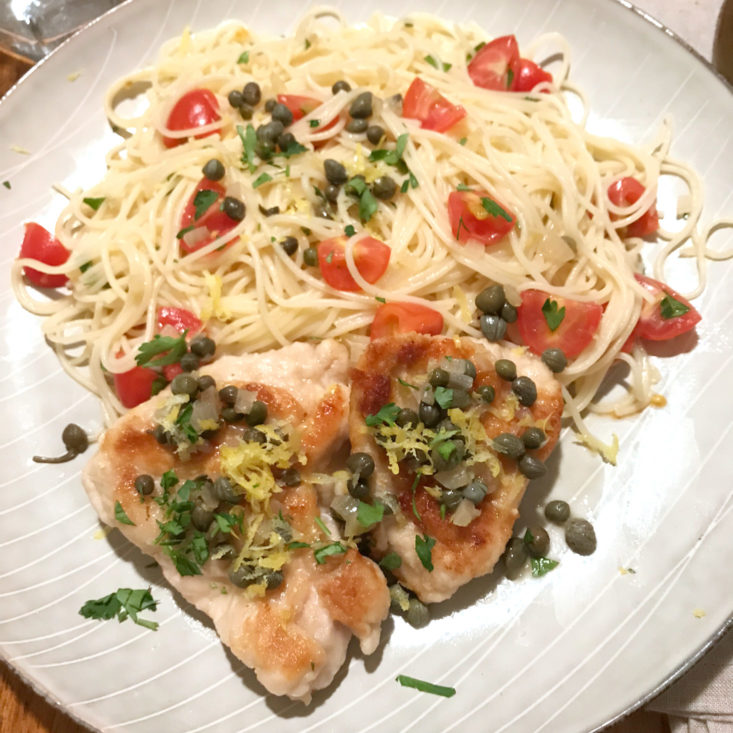 close up of plated chicken piccata with angel hair pasta