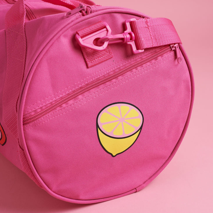 lemon on pink duffel bag