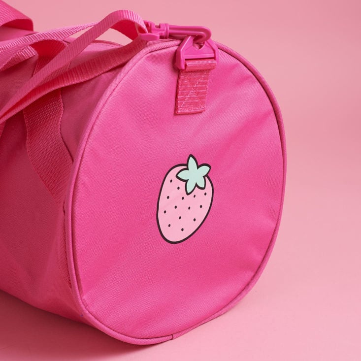 strawberry on pink duffel bag