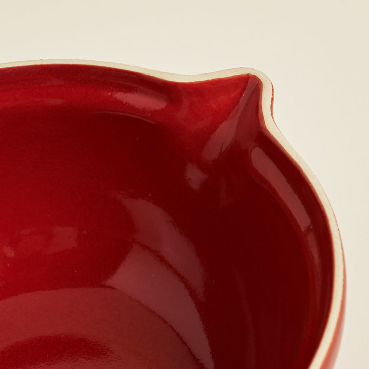 spout on red fondue pot
