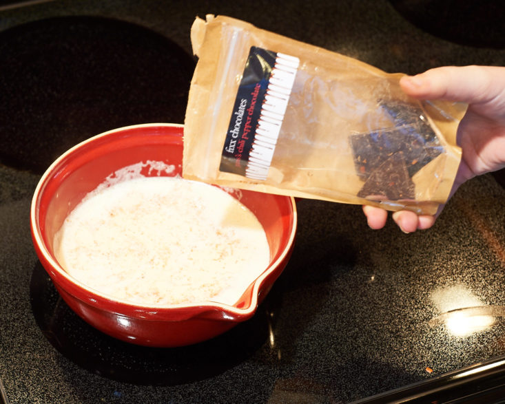 chocolate being poured into hot cream