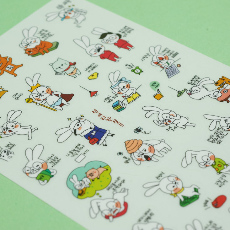 funny white bunny with glasses stickers close up on sheet