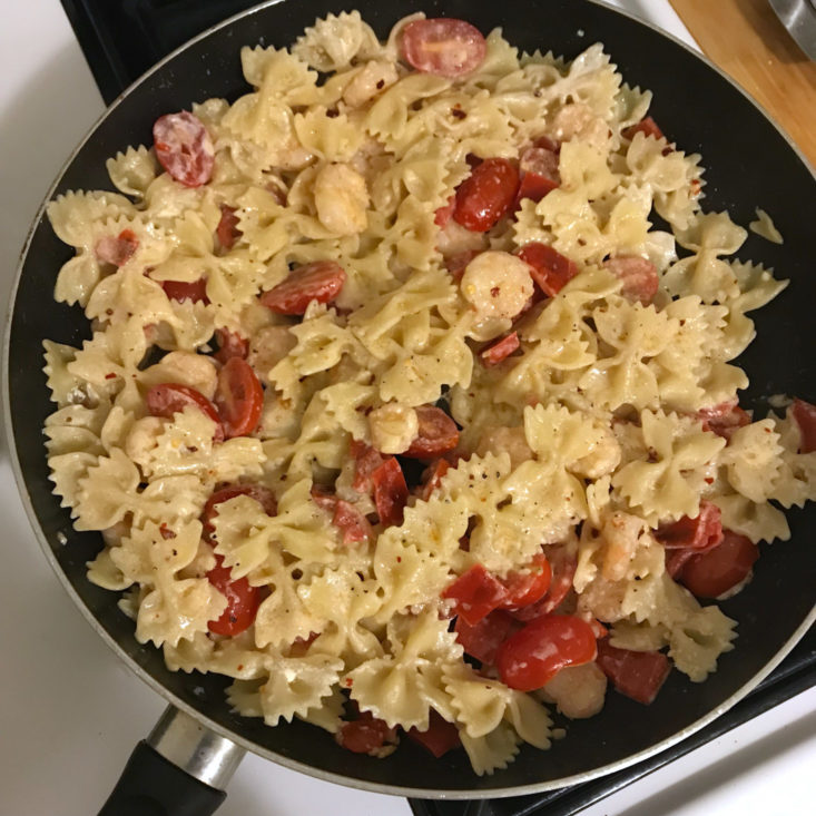 pasta, shrimp, tomatoes all added to pan