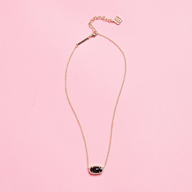 pendant necklace with black stone laid flat