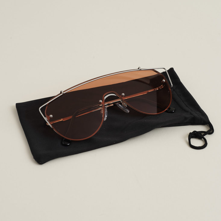 "Runner" sunglasses with flat rose colored lenses on cloth case