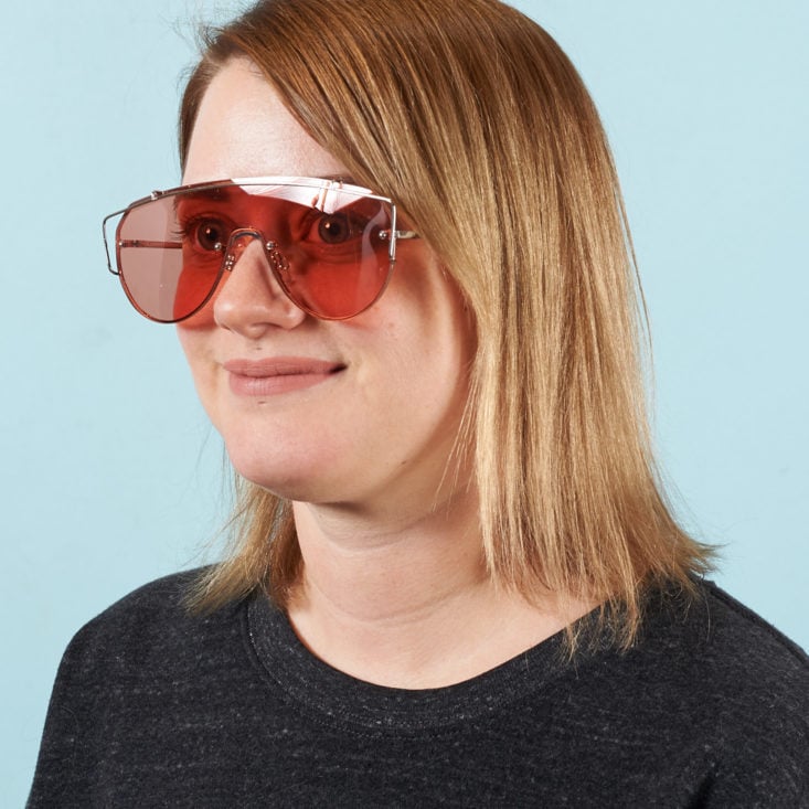 "Runner" sunglasses with flat rose colored lenses on model