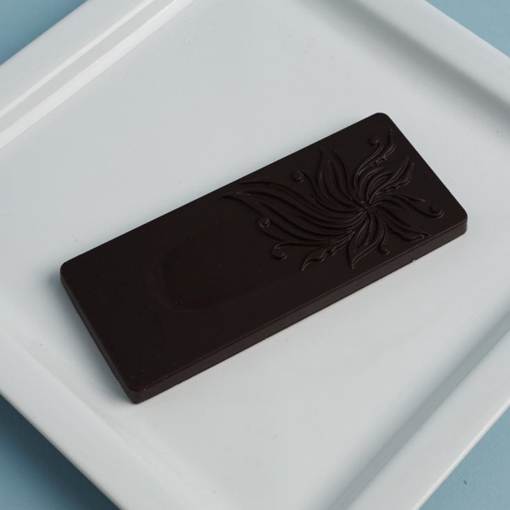 front of Elements Truffles Peppermint and Lavender Artisanal Chocolate Bar on plate