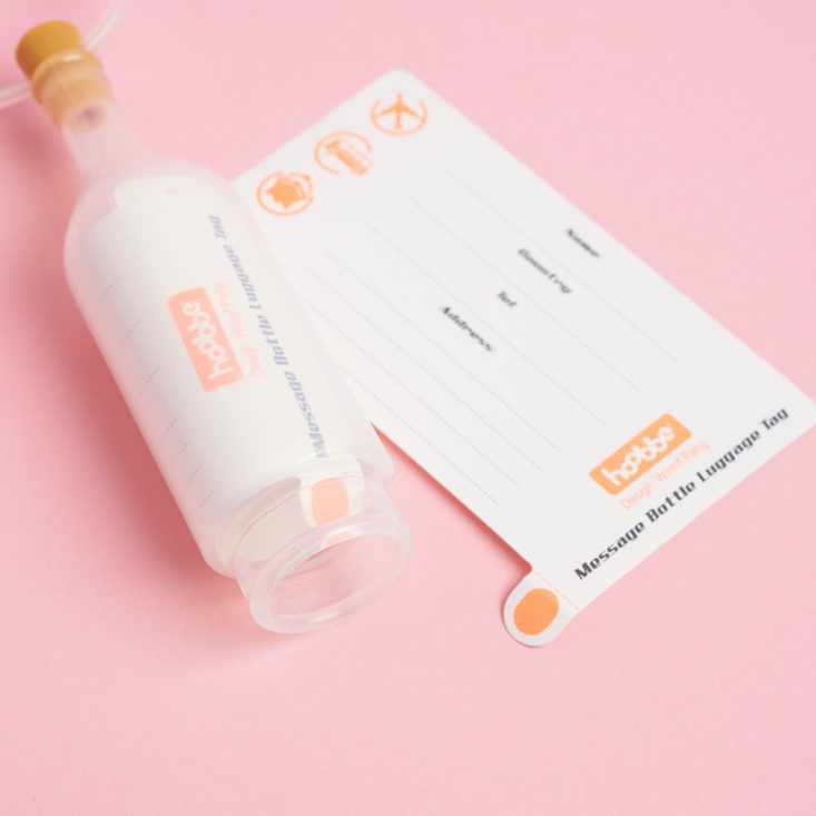 bottle and info sheet for luggage tag kit