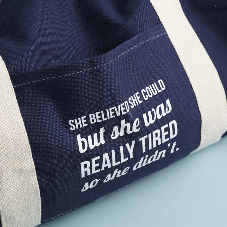 pocket detail on She believed she could duffle bag