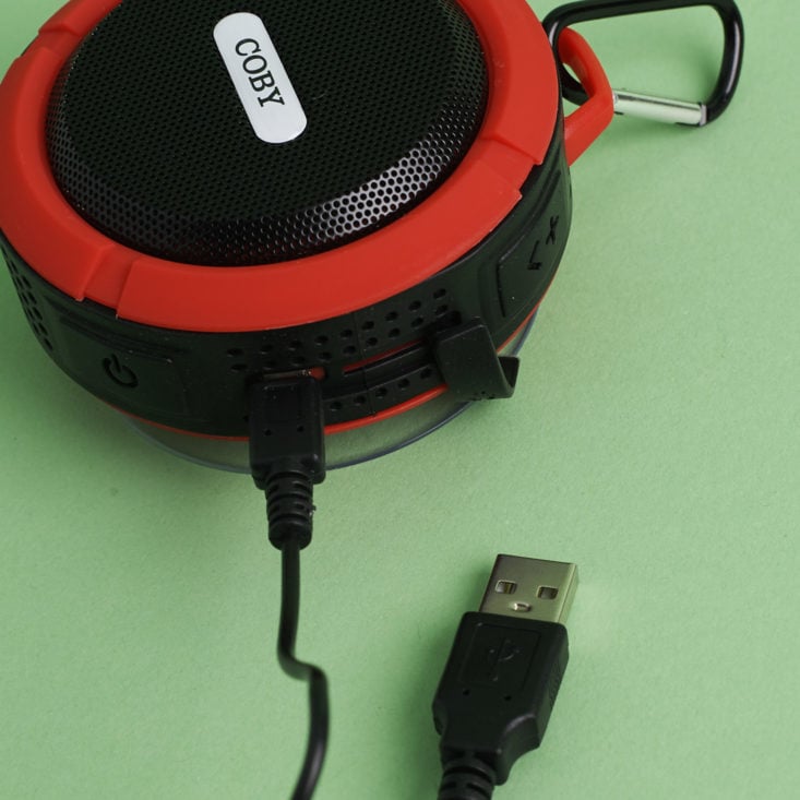 Coby USA Rugged Bluetooth Travel Speaker with charging cord plugged in