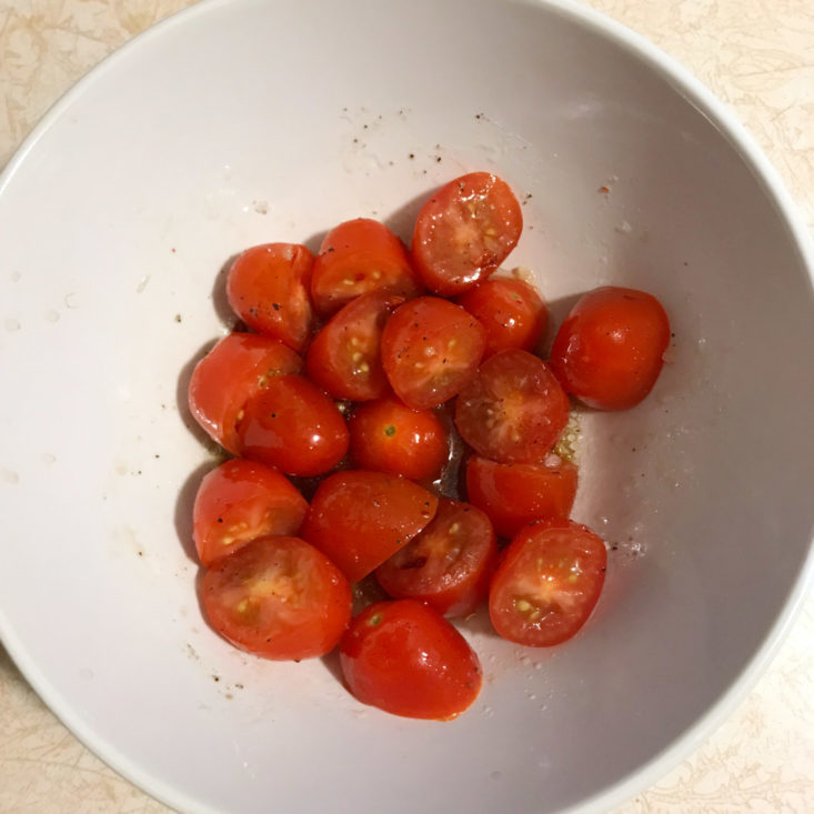 grape tomatoes marinating in bowl