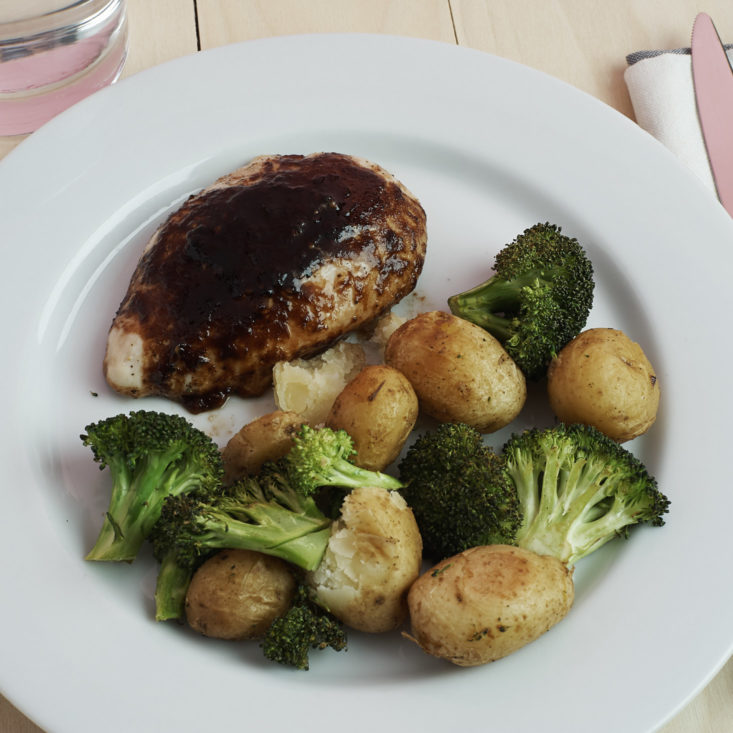close up of plated Chicken and Cherry Balsamic Sauce with Roasted Potatoes and Broccoli 