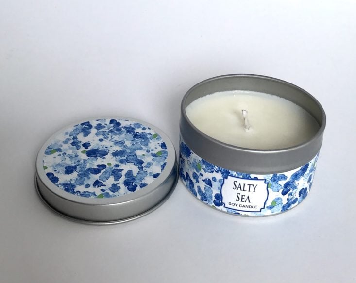 open B McVan Designs Salty Sea Candle Tin with lid to the left