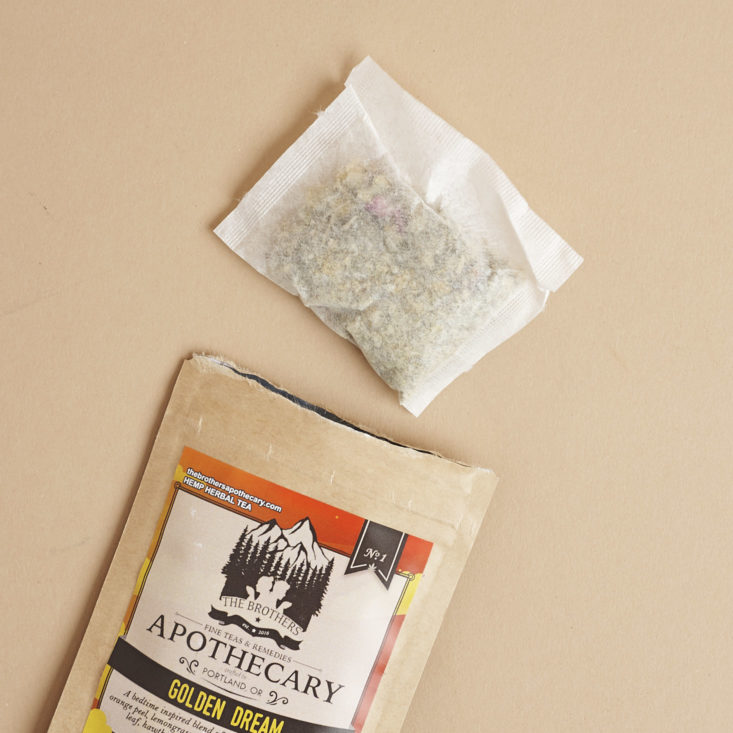 The Brothers Apothecary Golden Dreams CBD Tea Bag coming out of package