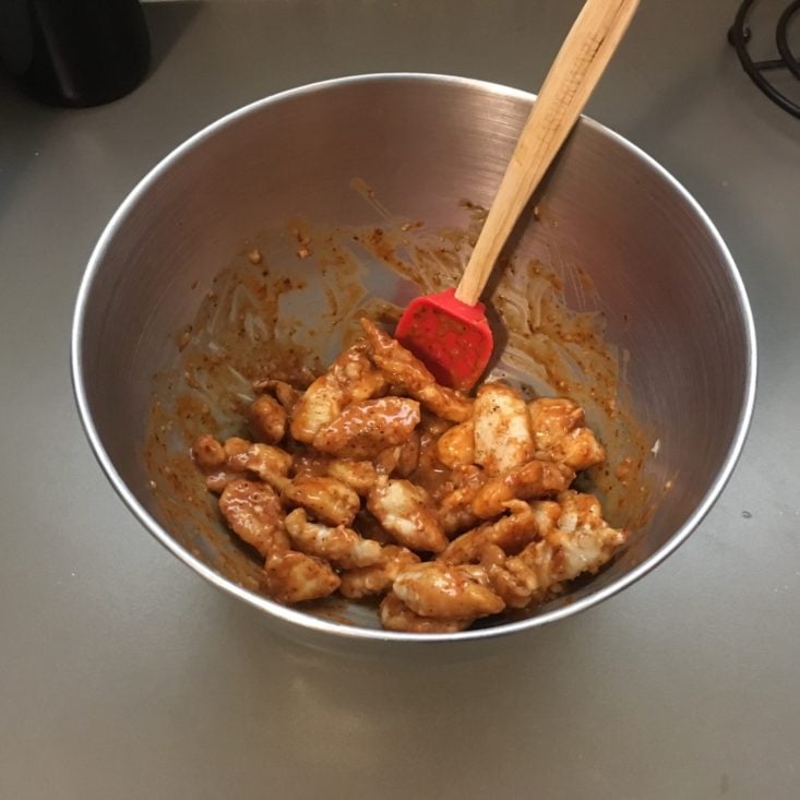 chicken mixed with sauce in a bowl