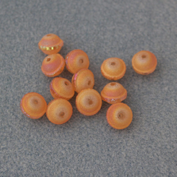 Bargain Bead Box August 2019 - 12 Pieces 10.5 x 8.5mm Glass Saturn Beads, Light Magma AB Top