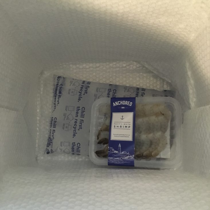 cooled shrimp at the bottom of the box with an ice pack