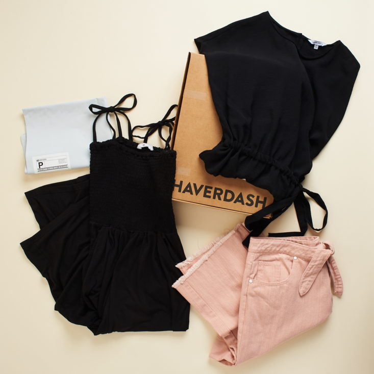 Three clothing items surrounding haverdash box