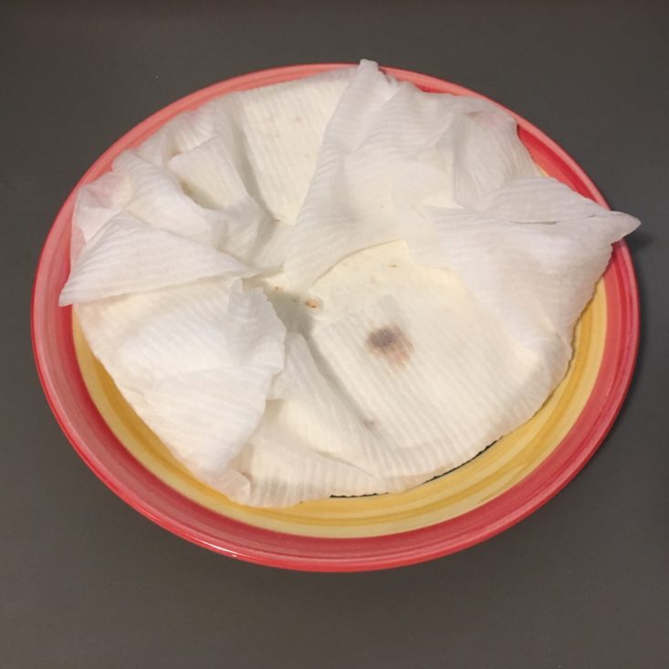 warmed tortillas in a paper towel