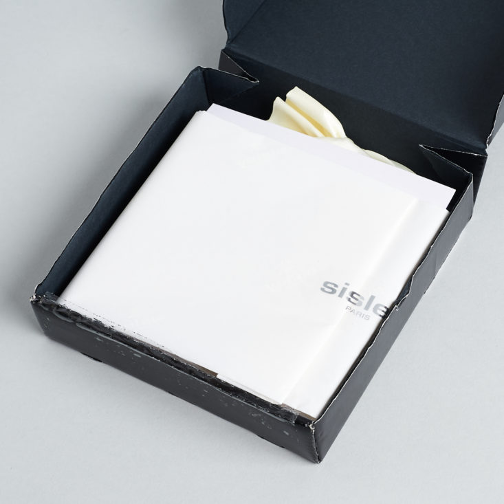 open black box with white tissue inside