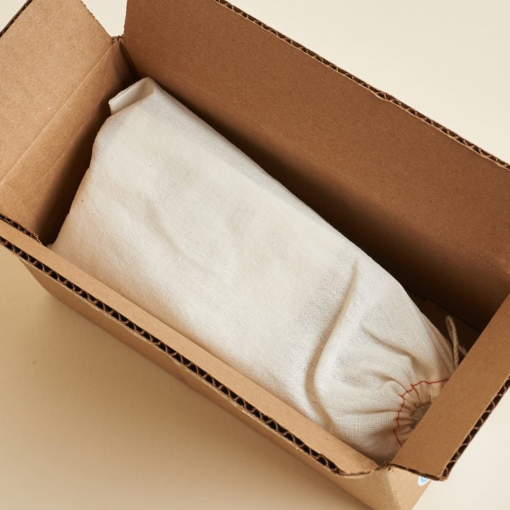 open brown box and linen bag inside
